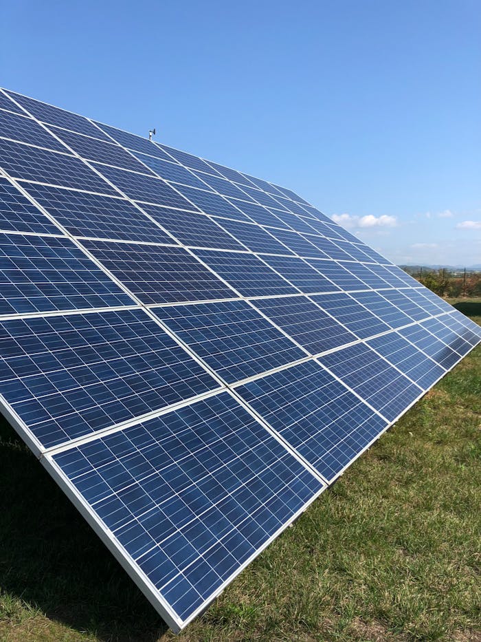 pexels-photo-16586167 Solar panels in a green field on a sunny day, showcasing renewable energy in Tortona, Italy.
